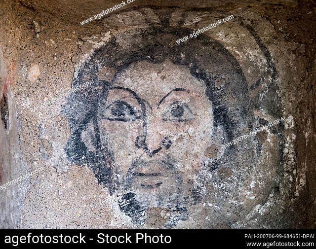 02 July 2020, Saxony-Anhalt, Zeitz: The drawing of a Christ's head with halo can be seen in the outer facade of the church of St. Michael