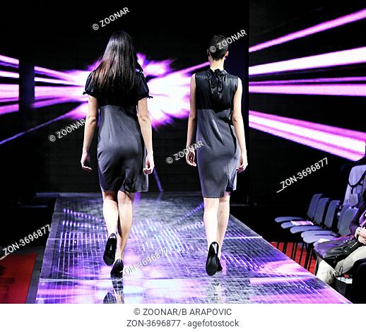 beautiful young fashion model woman walking on fashion show event