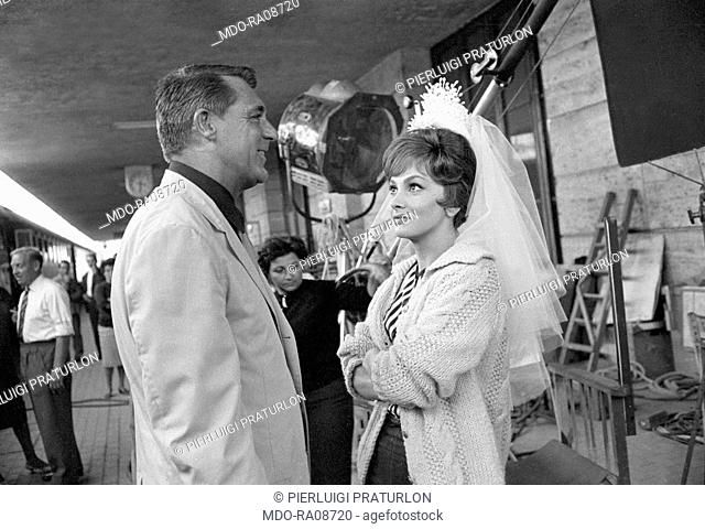 Italian actress Gina Lollobrigida and American actor Rock Hudson (Roy Harold Scherer Jr) talking in Termini station on the set of Come September