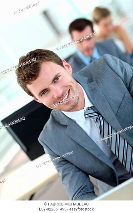 Salesman in grey suit attending business training