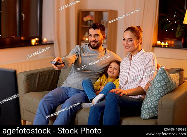 happy family watching tv at home at night