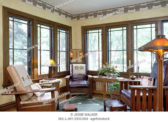 SUNROOM: Wide mullion windows, yellow walls, stylized Craftsman wallpaper border, mica shade on floor lamp, Arts and Crafts style leather upholstered oak...