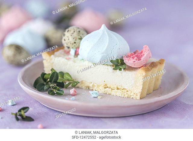 Slice of a Polish Easter cake with colorful meringues