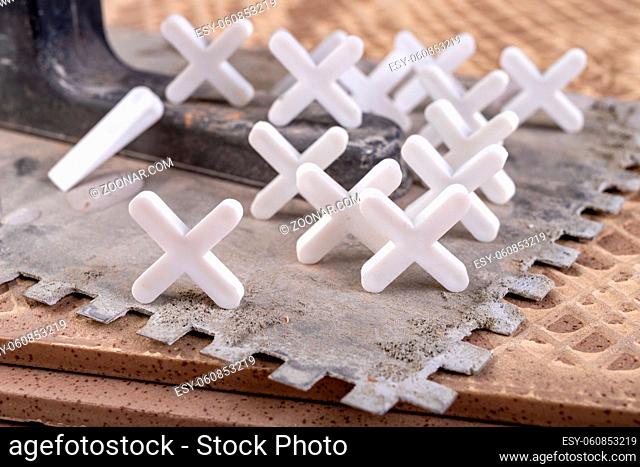 Industrial tiles and plastic crosses for tiling. Accessories for construction workers. Workplace - workshop
