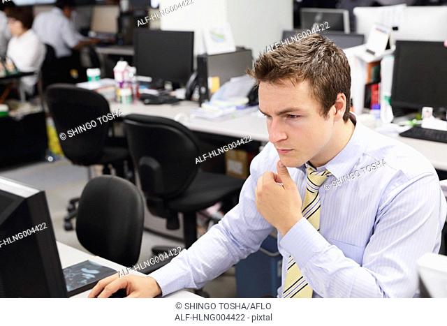 Caucasian businessman working late at his desk