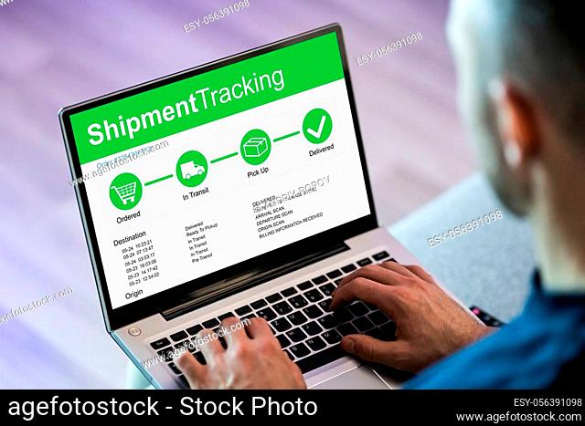 Man Checking Courier Service On Laptop Computer