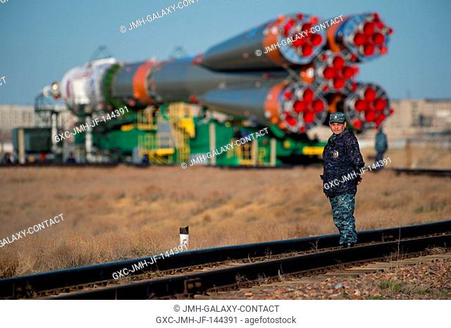 A Russian security officer is seen as the Soyuz MS-04 spacecraft is rolled out to the launch pad by train on Sunday, April 16