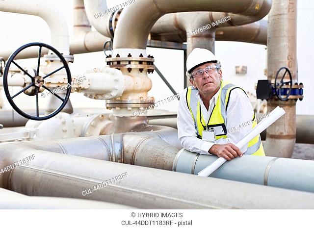 Worker on pipes at chemical plant