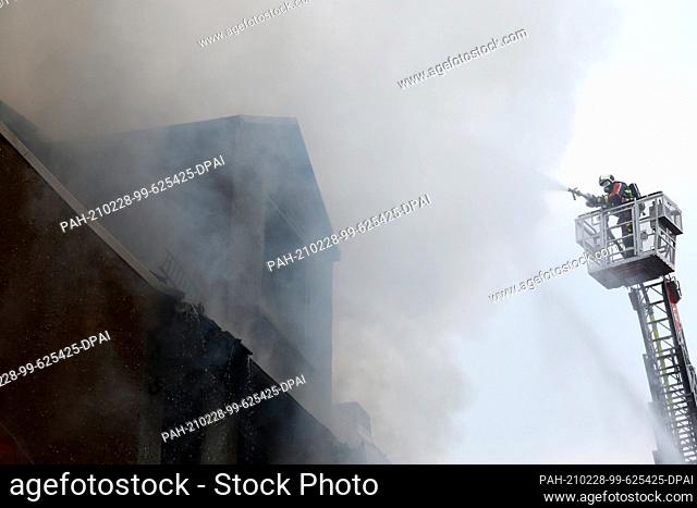 28 February 2021, Thuringia, Ronneburg: Firefighters extinguish a fire in the old town. In the city center of Ronneburg (Greiz district)