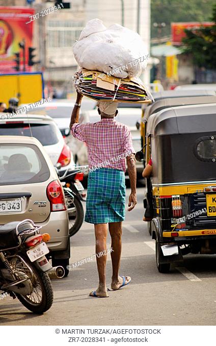 A man walks in busy traffic in Trivandrum , Kerala, South India