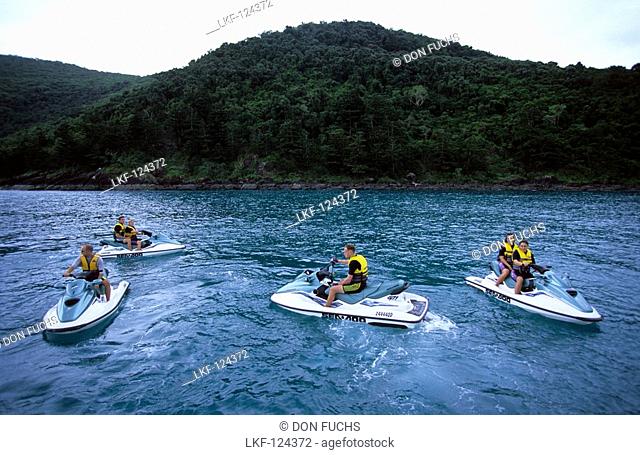 A group of people on a jet ski tour from Brampton Island. Carlisle Island in the background, Whitsunday Islands, Great Barrier Reef, Australia