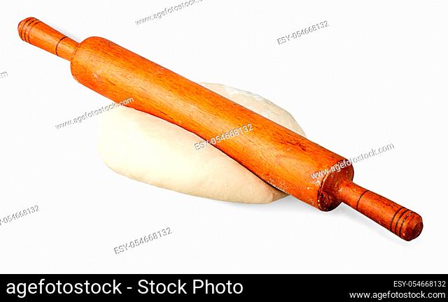 Rolling pin on a piece of dough isolated on white background