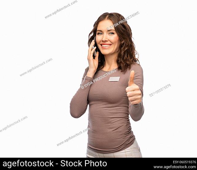 happy female shop assistant calling on smartphone