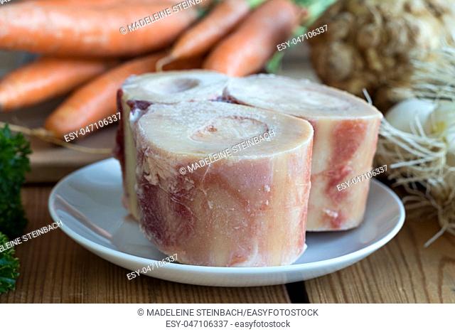Ingredients for making a beef bone broth - marrow bones, carrots, onions, celery root