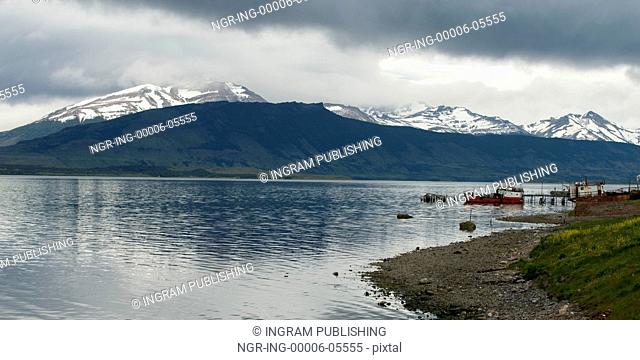 Lake with mountain range in the background, Golfo Almirante Montt, Puerto Natales, Patagonia, Chile