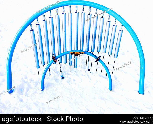 A giant musical instrument in snow in a public park, Ontario, Canada. A children’s play area. Open year round. Outdoors. All seasons. No hibernation