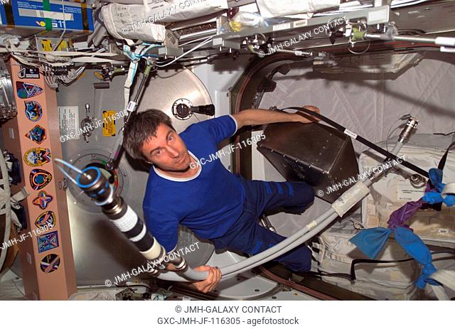 Cosmonaut Sergei K. Krikalev, Expedition 11 commander representing Russia's Federal Space Agency, participates in hardware transfers on the International Space...