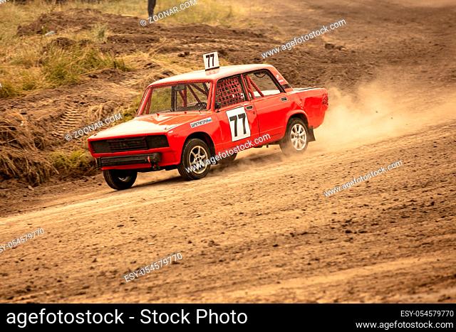 Traditional rally .The racing car drives into a steep turn, scattering, spraying dirt, dust. Extreme rally