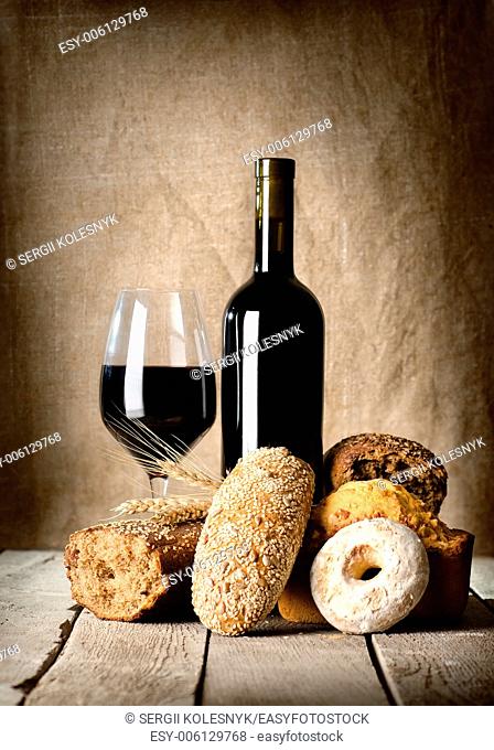 Wine and assortment of bread on the wooden table