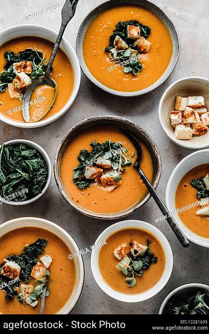 Pumpkin cream soup with kale and halloumi cheese