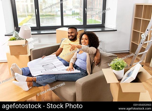 couple with boxes and blueprint moving to new home