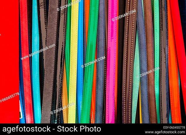 Wallpaper background of colorful leather belts showcased at a shopping store