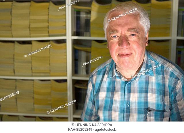 Author Helmut Rellergerd stands in front of a full book shelf in Bergisch Gladbach,  Germany, 14 September 2016. Rellergerd