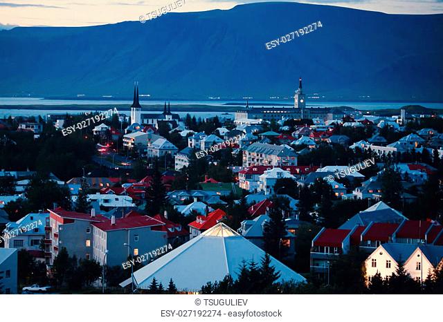 Beautiful super wide-angle aerial view of Reykjavik, Iceland with harbor and skyline mountains and scenery beyond the city