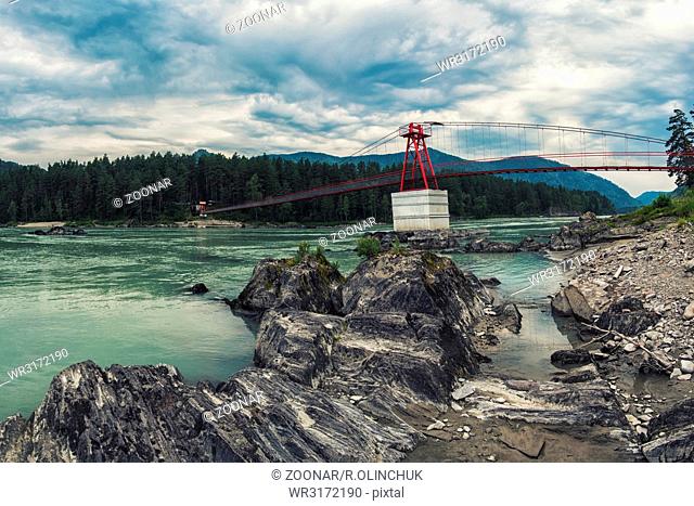 suspension bridge on mountain river