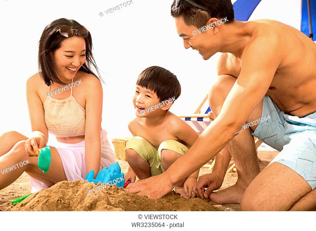 Happy family play on the beach