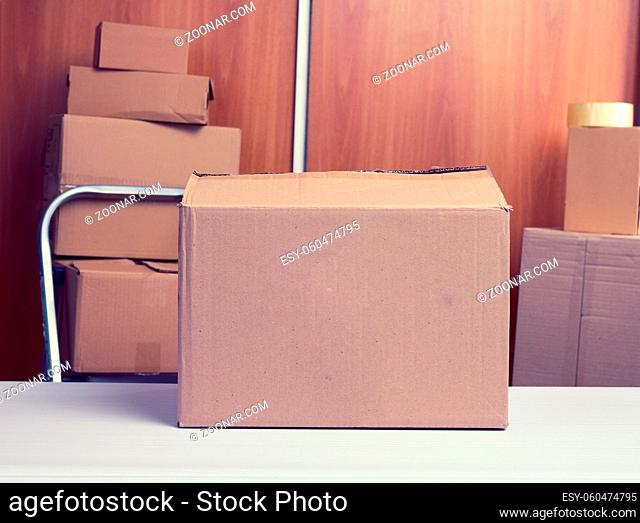 lot of brown cardboard boxes, the process of packing things when moving, help, volunteering
