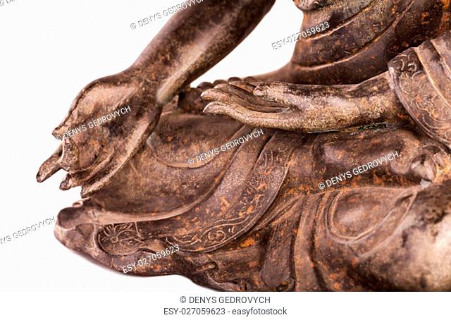 Buddha Shakyamuni's figure in a blessing pose - varada mudra. The old statue made of metal isolated on a white background
