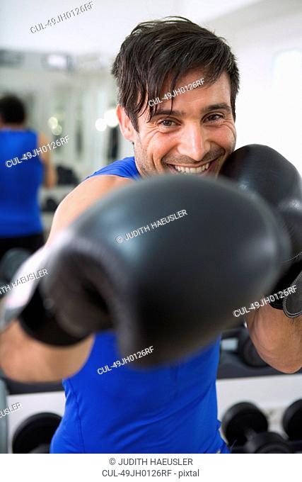 Boxer wearing boxing gloves in gym