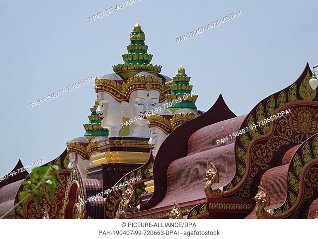 04 March 2019, Thailand, Ao Luek Distrikt: Pagoda roof and a statue with several faces on the property in Wat Maha That Wachira Mongkol or also Wat Bang Tong...
