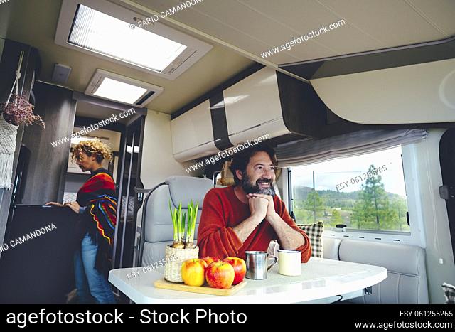 Travel people and off grid lifestyle living van life inside a camper. Happy serene couple enjoy van life with modern rv vehicle