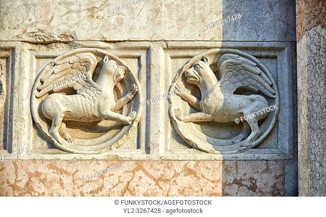Medieval relief sculptures of mythical griffins on the exterior of the Romanesque Baptistery of Parma, circa 1196, (Battistero di Parma), Italy