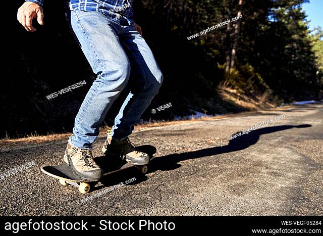 Man skateboarding on sunny day