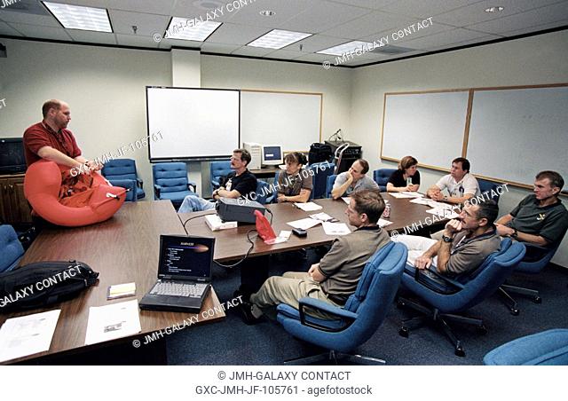 The STS-115 crewmembers are briefed by United Space Alliance (USA) crew trainer Bob Behrendsen during a classroom session of water survival training at the...