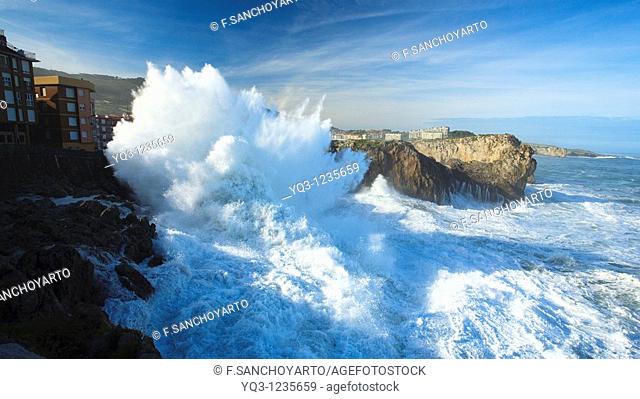 Northwestern waves breaking against buildings during storm. Castro Urdiales, Cantabria, Northern Spain