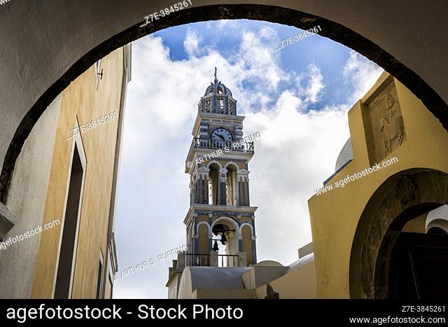 Clock tower of the Catholic Cathedral of Santorini (Cathedral of Saint John the Baptist). View through arch. Fira, Santorini, Greece, Europe