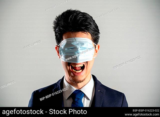Screaming man wearing a mask over his eyes