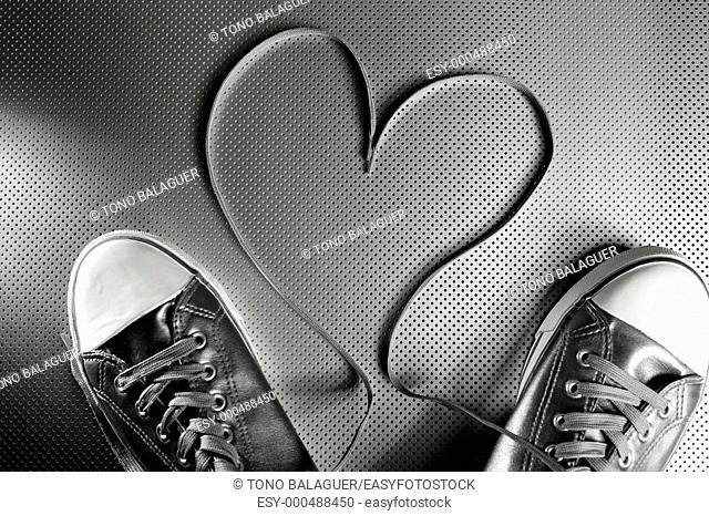 Laces of silver shoes, threads with heart valentines shape