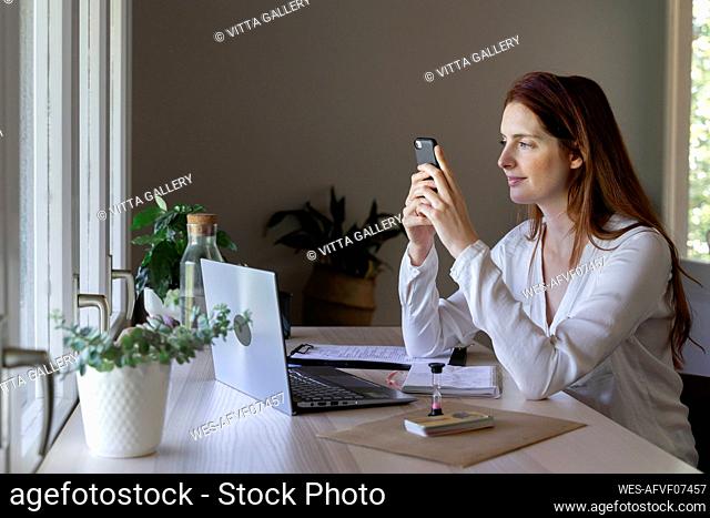 Psychologist using mobile phone while sitting at home