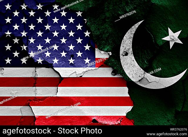 flags of USA and Pakistan painted on cracked wall