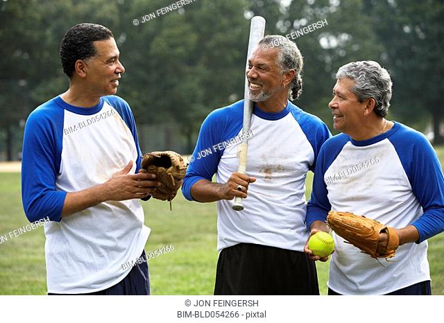 Multi-ethnic men with baseball gear