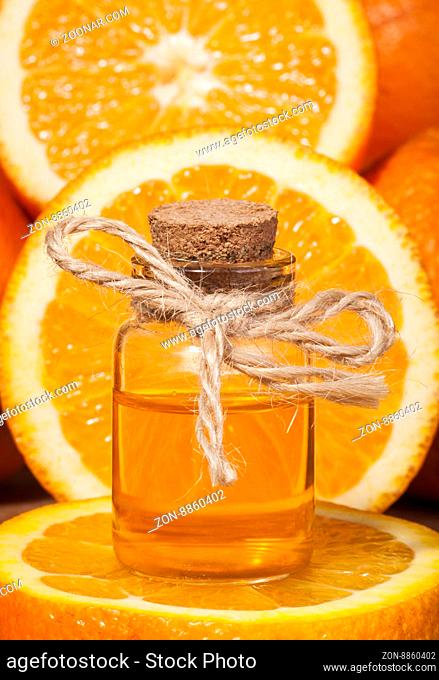 Bottle of essential oil from oranges on wooden background - alternative medicine