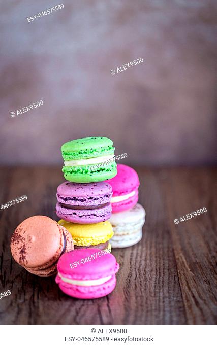Colorful macarons on the wooden background