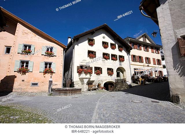 Village square with well, historic houses in Guarda, Lower Engadine, Grisons, Switzerland, Europe