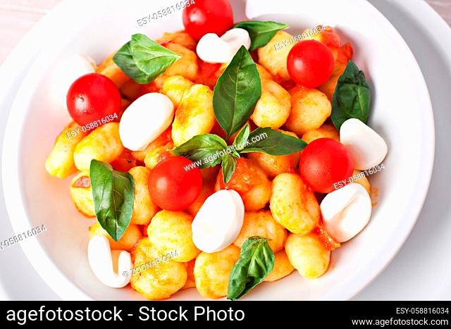 Homemade gnocchi with tomato sauce basil and mozzarella. High quality photo