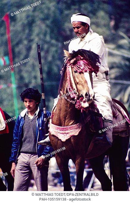 Equestrians on their horses are preparing for a Fantasia, analogue undated recording of March 1985. A Fantasia is a traditional equestrian sport in which riders...